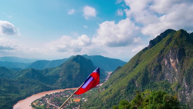 Time lapse: Laos landscape motion clouds Nong Khiaw from the Pha Daeng mountain top national flag, dramatic sky, scenic mountains and limestone pinnacle, famous travel destination in South East Asia