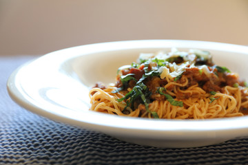 spaghetti Bolognese with minced beef and tomato sauce garnished with parmesan cheese and basil , Italian food