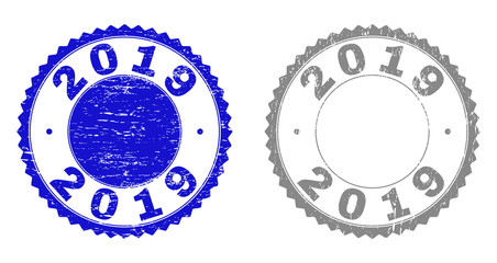 2019 stamp seals with distress texture in blue and gray colors isolated on white background. Vector rubber watermark of 2019 title inside round rosette. Stamp seals with retro textures.
