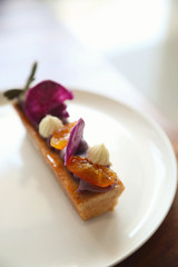 Sweet homemade fance peach cake on wooden table
