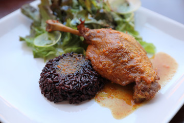 duck confit with rice and salad , italian food style