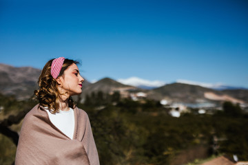 Young Russian girl enjoys spring sun in the countryside