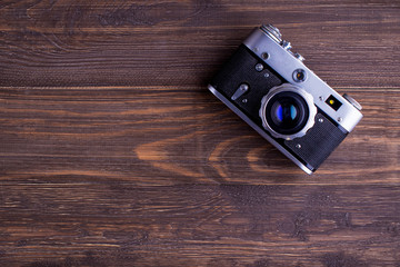 Vintage camera on wooden background,top view