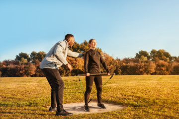 Personal trainer training a girl outside