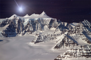Mountain ridges sof the Geikie Plateau region in eastern Greenland, Aerial view with milky way and lens flare. Elements of this image furnished by NASA - Powered by Adobe