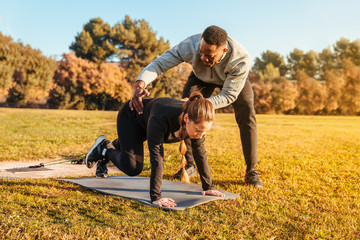 Personal trainer training a girl on the outside