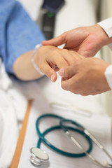 Patient on bed with doctor holding hands for nursing, medical health care, caregiver and in-patient ward healthcare concept