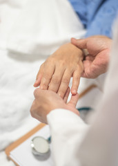 Patient on bed with doctor holding hands for nursing, medical health care, caregiver and in-patient ward healthcare concept
