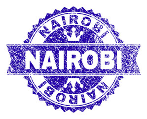 NAIROBI rosette seal watermark with distress effect. Designed with round rosette, ribbon and small crowns. Blue vector rubber watermark of NAIROBI label with unclean style.