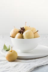 Pickled apples in bowl on white stone table. Close up. Traditional Russian food.