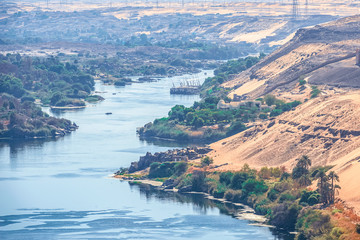 Sunset over the Nile River in the city of Aswan with sandy and deserted shores