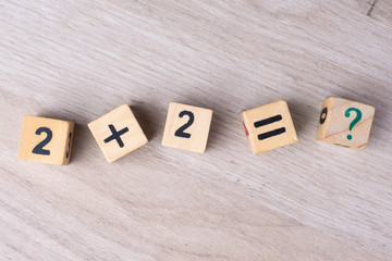 Wooden cubes with numbers. Teaching a child of preschool age mathematics. question mark. child learns numbers