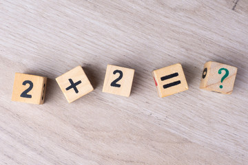 Wooden cubes with numbers. Teaching a child of preschool age mathematics. question mark. child...