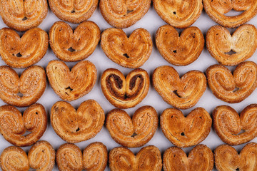 group of sugar cookies in the shape of a heart on a light background