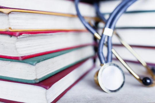 Medical Student Multicolor Textbook And Stethoscope. Collection Of Scientific Papers