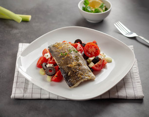 grilled fish with vegetables on plate