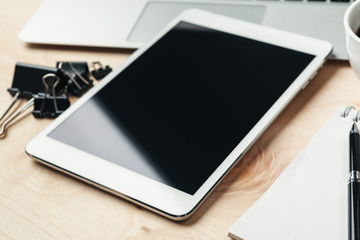 electronic gadgets and office supplies on wooden table