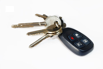 isolated of house key with alert security remote plastic black control, set of house metal keys with alarm remote control on white background, isolated of house and car keys