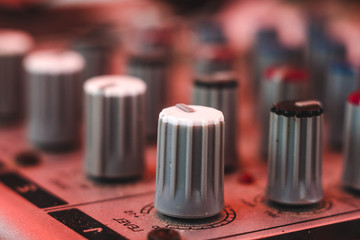 Part of an audio sound mixer with buttons and sliders