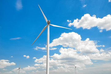 The wind generator is in bright cloudy sky. Eco energy concept.