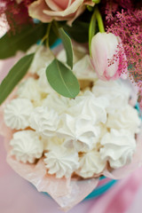 meringue in a blue box and beautiful bouquet