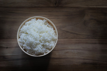 White steamed rice in brown bowl.