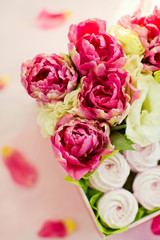 Box with various flowers and sweets