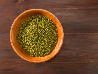 Green gram in bowls on a brown background