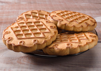 Cookies closeup on light brown wooden background