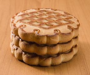 Three cookies closeup on wooden background