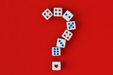 Question mark made of dices and heart on red background - Concept of risk and chance on love