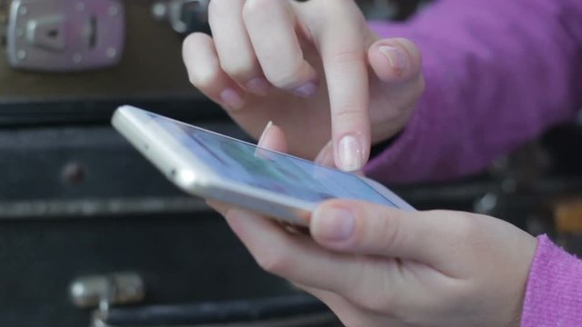 Closeup of young woman hands scrolling pictures phone. surfing internet