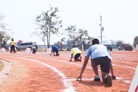 Back View Of Students Ready To Start Run On Running Track