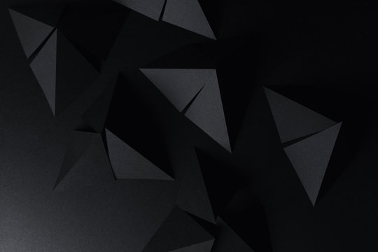 Pyramidal shapes of black paper, abstract background