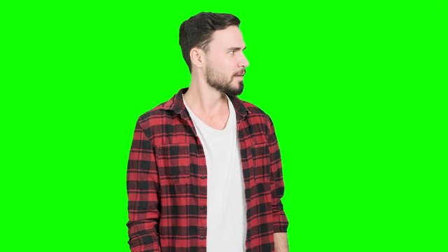 Young man acting upset and disgusting and hand cover his mouth. White male, green screen for chroma key.
