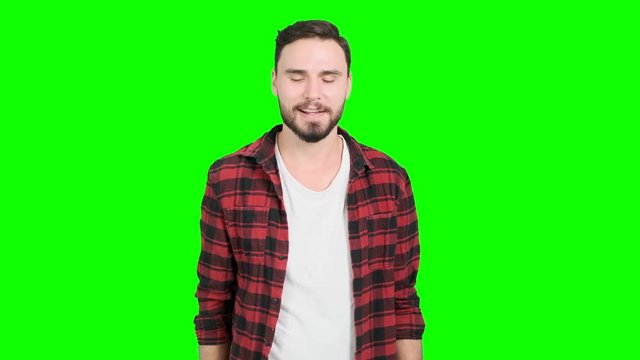 Young man showing his okay sign on green screen, happy smile. White male. For Chroma key.