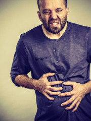 Man feeling stomach ache pain