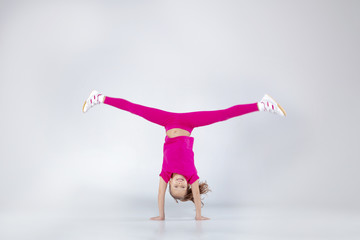 Young caucasian girl doing gym exercises in sportwear
