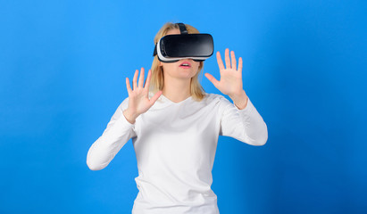 Funny young woman with VR. Beautiful woman wearing virtual reality goggles in studio. Woman using VR device. Technology VR.