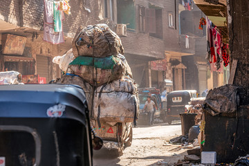 18/11/2018 Cairo, Egypt, transportation on the street of garbage town among a bunch of rubbish and unacceptable stench on a sunny day © Oleksii Hlembotskyi