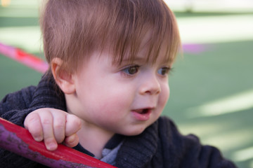 Image of sweet baby boy, closeup portrait of child on playground