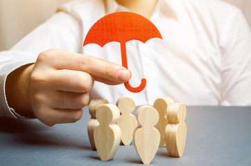 Boss holding a red umbrella and defending his team with a gesture of protection. Life insurance....
