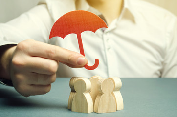 Boss holding a red umbrella and defending his team with a gesture of protection. Life insurance....
