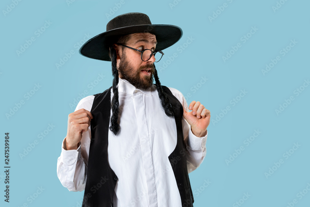 Wall mural portrait of a young orthodox hasdim jewish man at jewish festival of purim at studio. the purim, jew