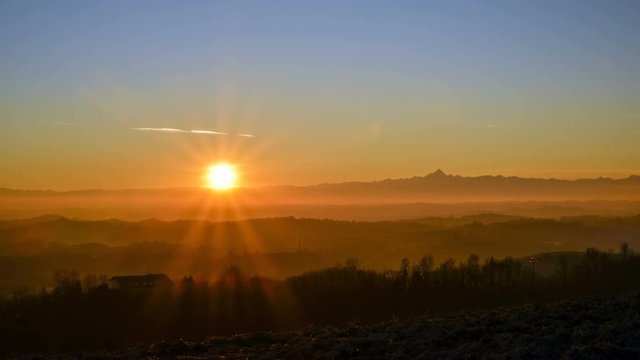 Panoramic view of a sunset on the Alps from a hill in the Montferrat