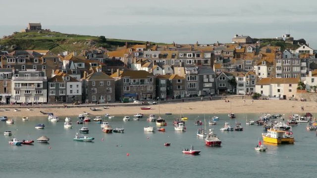 View of St Ives harbour with fishing boats and sandy beach, Cornwall, England