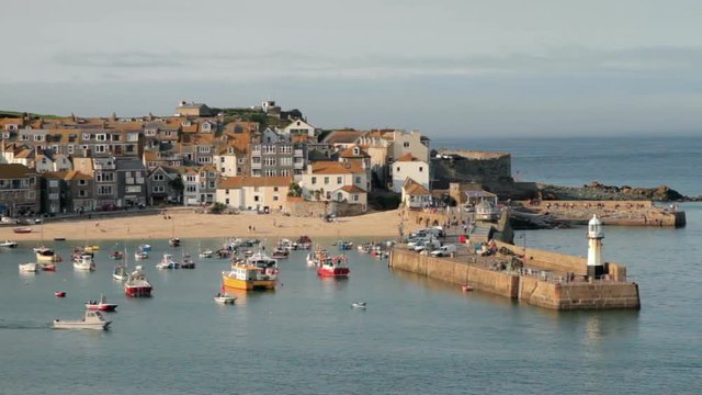 View of St Ives harbour with fishing boats and sandy beach, Cornwall, England