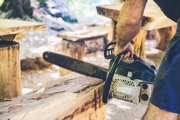 A man with a chainsaw cutting wood