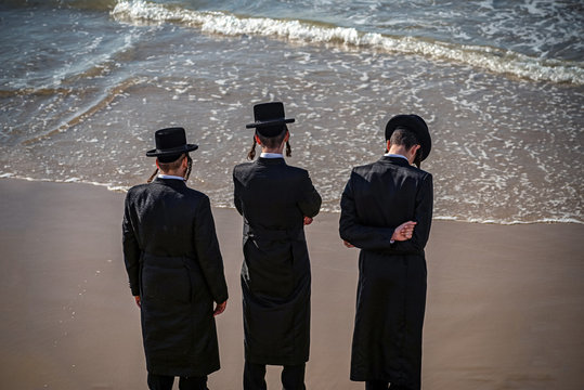 .young Jews on the coast of the Mediterranean Sea in traditional dress