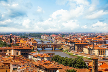 Fototapeta na wymiar Firenze landmarks. Florence, Italy. Panorama cityscape with red roofs and bridge Ponte Vecchio and the Arno river in Florence